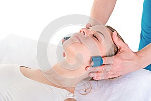 Beautiful young woman having a face massage in professional Phys