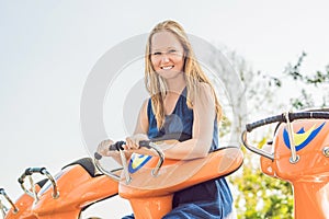 Beautiful, young woman having fun at an amusement park