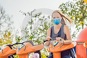 Beautiful, young woman having fun at an amusement park Tourists fear the 2019-ncov virus. Medical masked tourists