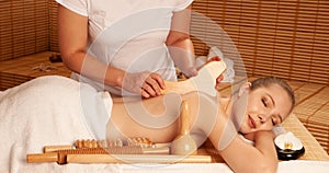 Beautiful young woman having a maderotherapy massage treatment