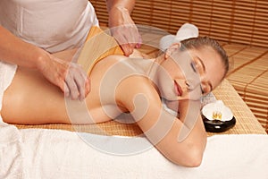 Beautiful young woman having a maderotherapy massage treatment photo