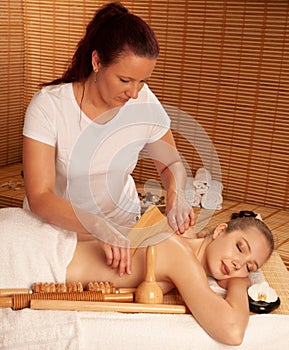 Beautiful young woman having a maderotherapy massage treatment photo