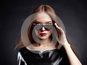 Beautiful young Woman with healthy Hair in Sunglasses