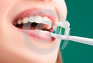 Beautiful young woman with healthy teeth, beautiful female smile. Close-up mouth with teeth-brush. Toothbrush with