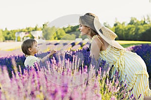 Beautiful young woman and her baby son in the lavender field photo