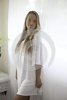 Beautiful young woman in her bedroom