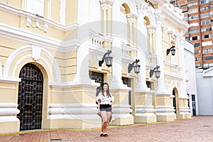 Beautiful young woman at the historical Municipal Theater built in 1918 located in the downtown of the city of Cali in Colombia
