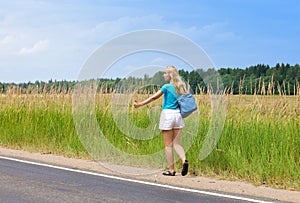 Beautiful young woman hitch hiking- in auto-stop