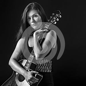 Beautiful young woman holding acoustic guitar