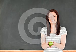 Beautiful young woman holding an apple