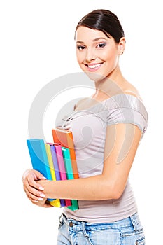 Beautiful young woman holding books