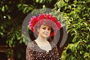 Beautiful young woman with peony flowers