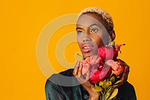 beautiful young woman holding bouquet of red peony flowers