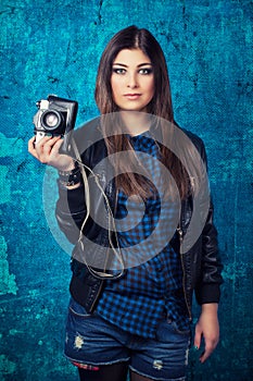 Beautiful young woman holding camera