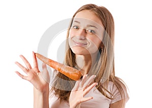 Beautiful young woman holding a carrot in the hands