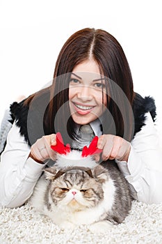 Beautiful young woman holding a cat, isolated against white background