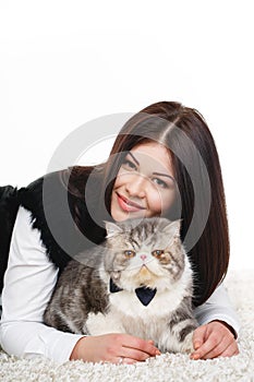 Beautiful young woman holding a cat, isolated against white background