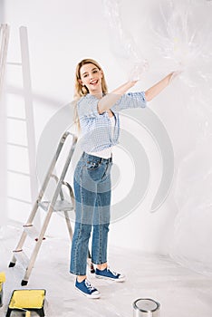 Beautiful young woman holding cellophane while