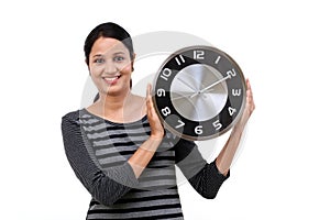 Beautiful young woman holding clock