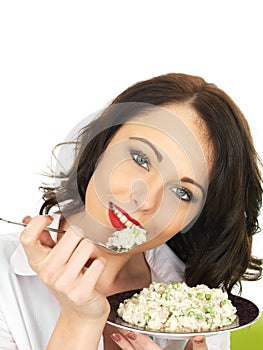 Beautiful Young Woman Holding and Eating a Plate of Italian Style Risotto