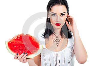 Beautiful young woman holding and eating slice of ripe red fresh juicy sweet watermelon