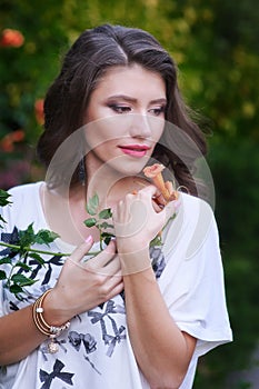 Beautiful young woman holding a flower