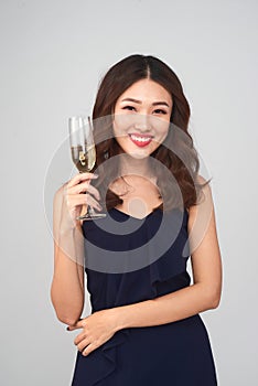 Beautiful young woman holding glass of champagne