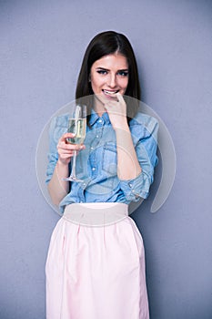 Beautiful young woman holding glass of champagne