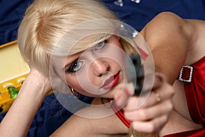 Beautiful young woman holding gun, focus on face