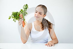 Beautiful young woman holding healthy food in hands on the light