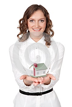 Beautiful young woman holding house model