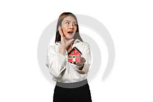 Beautiful young woman holding house model isolated on white background. Real estate, property and insurance