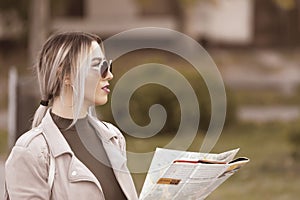 Beautiful young woman holding map