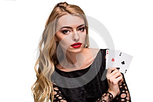 Beautiful young woman holding two ace of cards in her hand isolated on black background