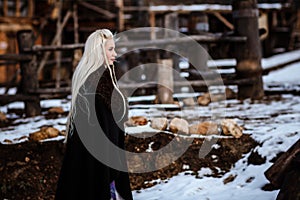 Beautiful young woman holding a viking with blond hair. Image of Historical figure