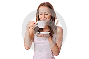 Beautiful young woman holding a white cup and saucer with coffee tea