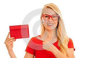 Beautiful young woman holds red envelope - a love letter for va