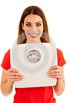 Beautiful young woman holds scale as a sign of weightloss isolated over white background