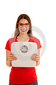 Beautiful young woman holds scale as a sign of weightloss isolated over white background