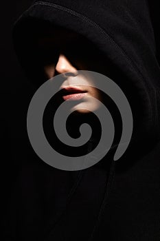 beautiful young woman in hood. face of girl under Hoodie