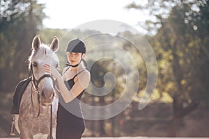 Beautiful young woman with a horse