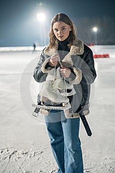 Beautiful young woman ice skating