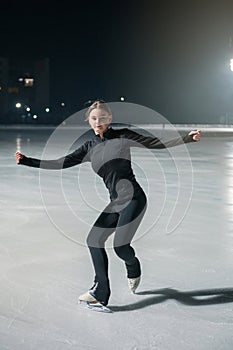 Beautiful young woman ice skating