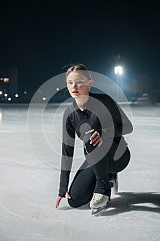 Beautiful young woman ice skating and performing short program