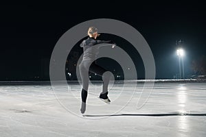 Beautiful young woman ice skating and performing short program