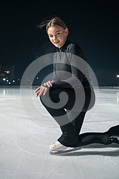 Beautiful young woman ice skating and performing short program