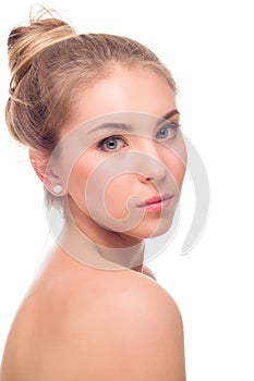 Beautiful Young Woman isolated on a White Background. Touching Her Face. Fresh Clean Skin.