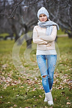 Beautiful young woman in jacket in autumn park