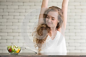 Beautiful young woman in joyful postures with salad bowl