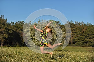 Beautiful young woman jumping in blooming meadow